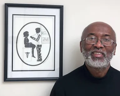 Framed medical illustration with smiling man beside it.