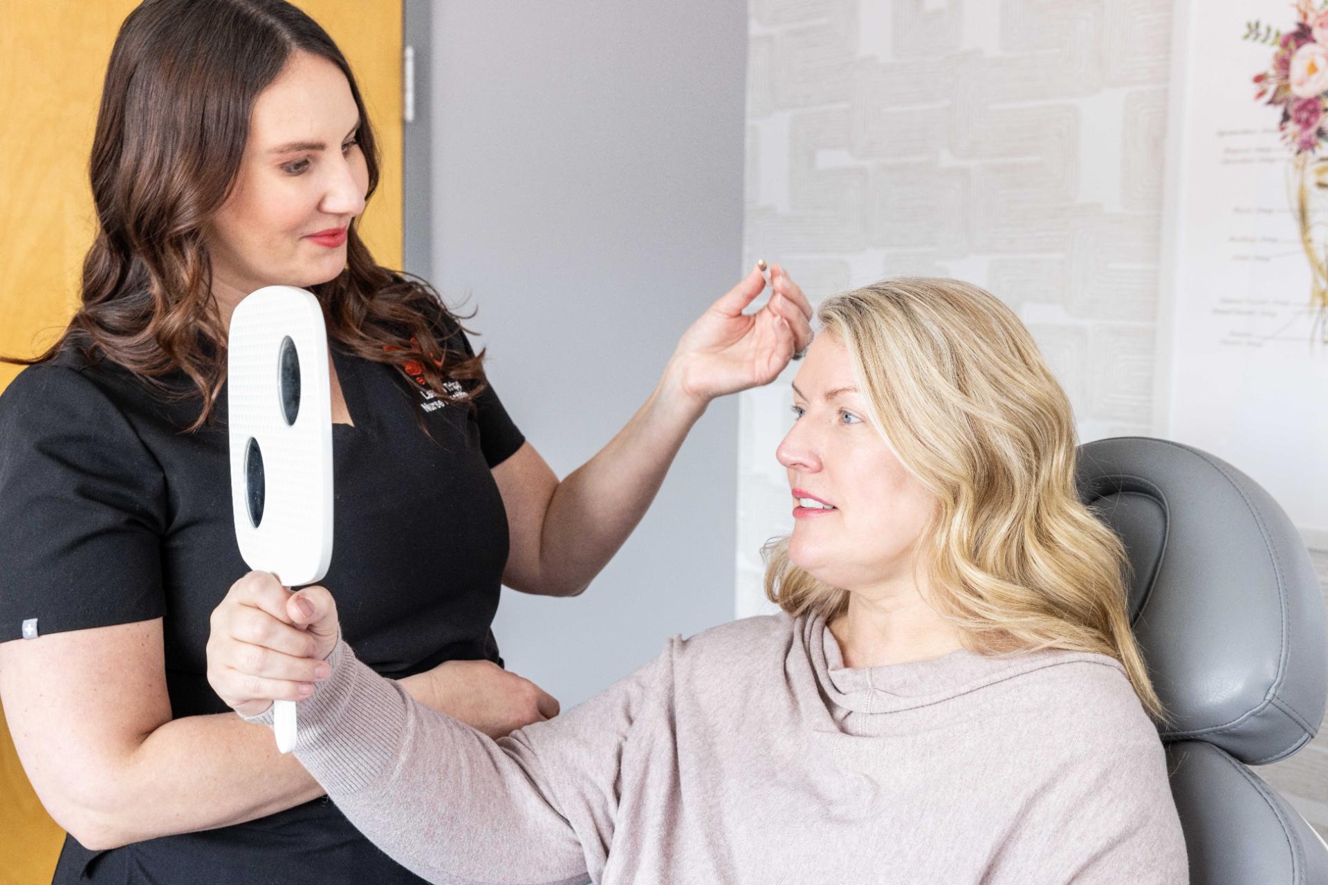 Consultation between two women in a clinic setting.