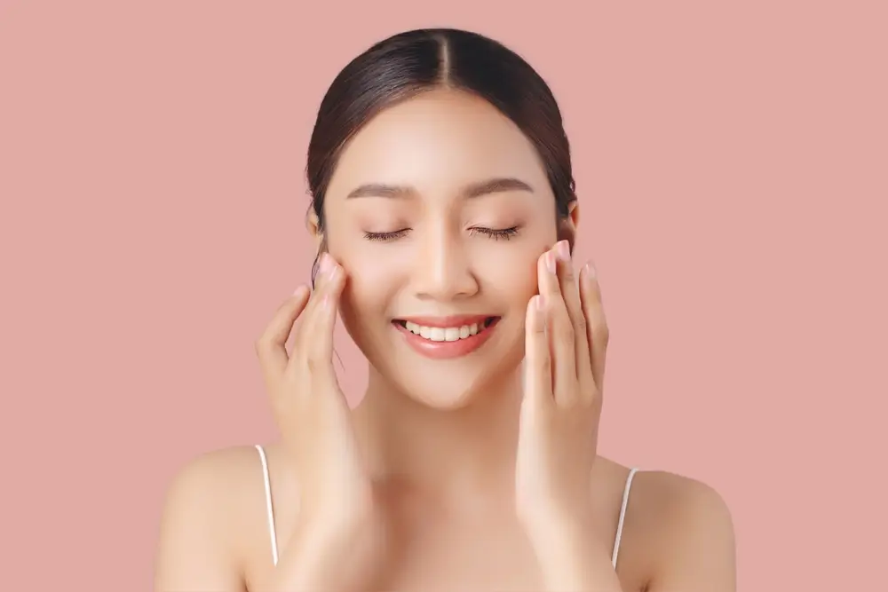 Woman enjoying skincare routine, relaxed expression.