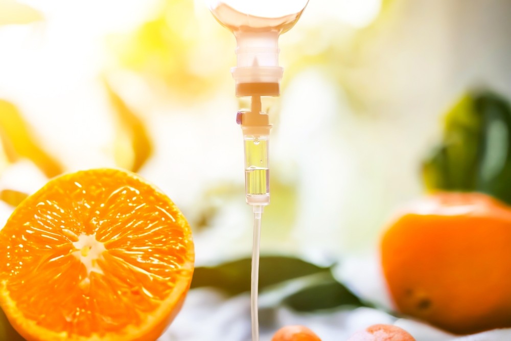 IV drip with oranges, highlighting vitamin C infusion benefits.