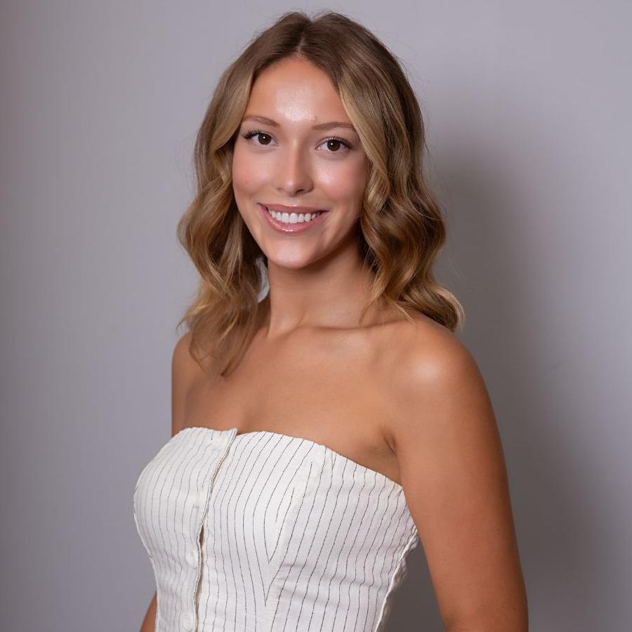 Smiling woman in a strapless top.